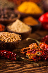 Plenty of traditional Asian spices in wooden bowls