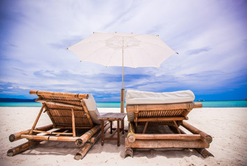 Beach wooden chairs for vacations on tropical beach