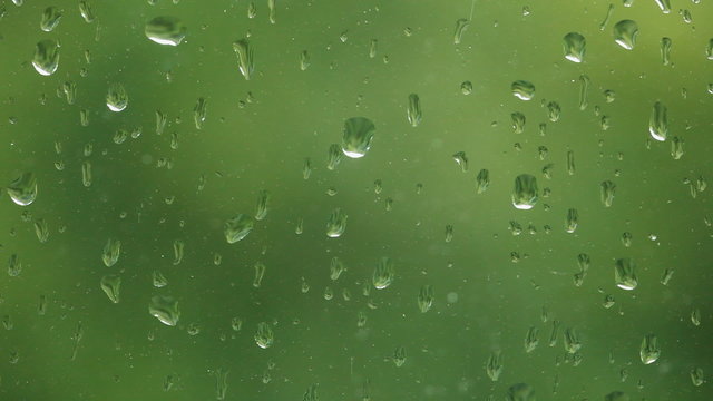 Close up of a window with rain drops falling down 