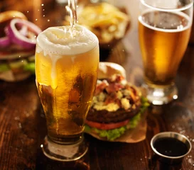 Peel and stick wall murals Beer beer being poured into glass with gourmet hamburgers