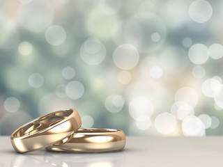 Obrazy na Szkle  Para złotych obrączek ślubnych z tłem bokeh