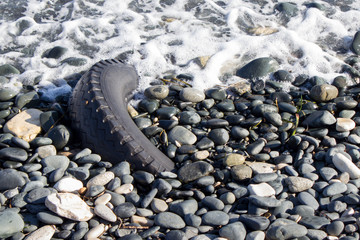 Tire on sea shore