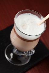 Hot chocolate in glass with chocolate on stick