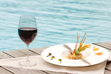 tartare with lampuga fish, celery, and food garnish with red win