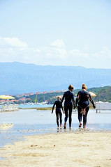 People smeared with healing mud on the sand beach