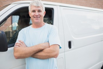 Smiling man in front of delivery van