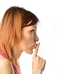 Girl making silence gesture over isolated white background