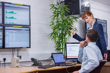 Focused colleagues analyzing result on their computer