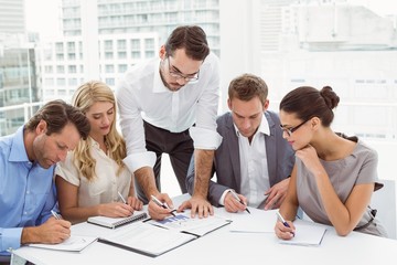 Fototapeta premium Executives writing notes in office