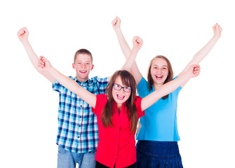 Group of happy teenagers raising hands