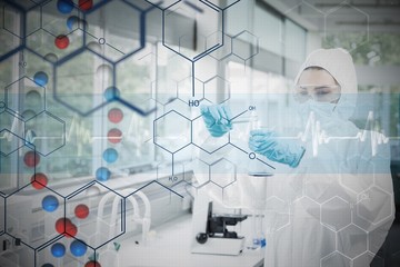Chemist in protective suit working with futuristic interface