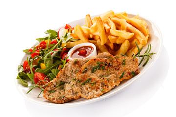 Pork chop, French fries and vegetables