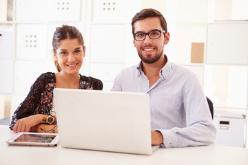 Businesspeople Using Laptop In Office Of Start Up Business
