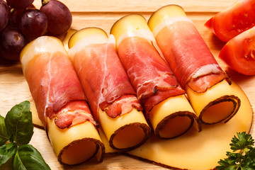 Cheese and ham on cutting board