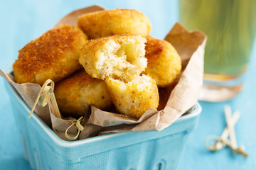 Potato croquettes with fish, served with beer