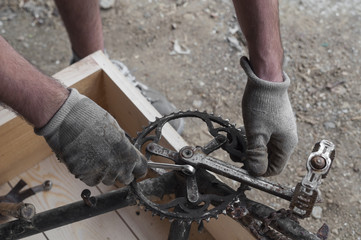 Mechanic reiparing a bike, chainring and pedals