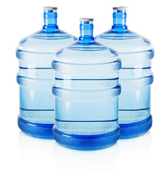 Three big bottles of water isolated on the white background © Iurii Kachkovskyi