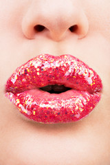 Fototapeta premium beautiful female lips with shiny red gloss lipstick
