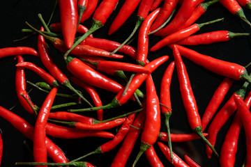 Red chillies on black background