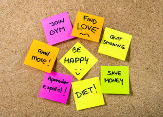 group of New year Resolutions Post it notes on board