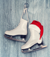 Pair of White Ice Skates and Santa Claus hat - backround on vint - 71699174