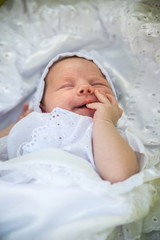 Little Newborn Sleeping over Her White Bed on white background