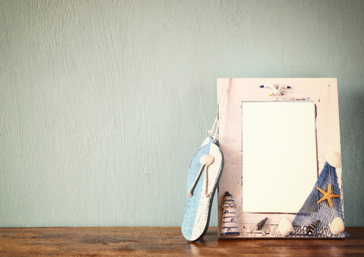 vintage nautical frame on wooden table. retro filtered image
