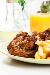 Chicken wings with fries french and spicy sauce