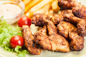 Chicken wings with fries french and spicy sauce