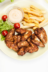 Chicken wings with fries french and spicy sauce