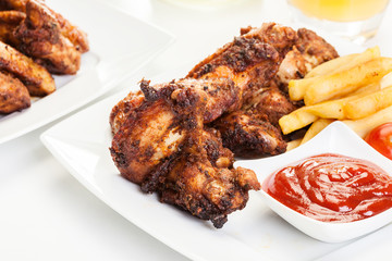 Chicken wings with fries french and spicy sauce