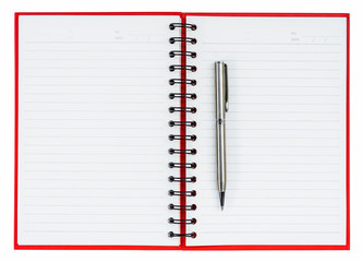 Silver ball point pen on red notebook
