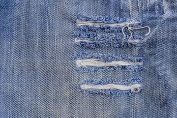 texture of old blue jeans at torn