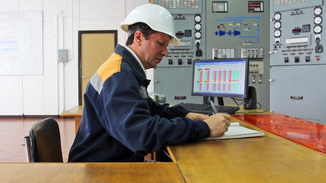 engineer sits at table workplace and something logs, part1