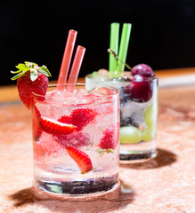 Two glasses of strawberry and grape mojitoes