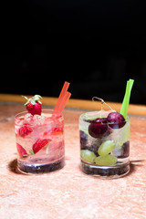 Two glasses of strawberry and grape mojitoes