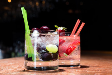 Two glasses of strawberry and grape mojitoes