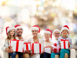 happy family in santa helper hats with gift boxes