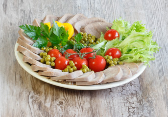 Boiled beef tongue on wooden background