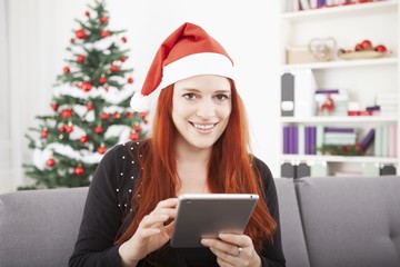 girl reading something for christmas on the tablet