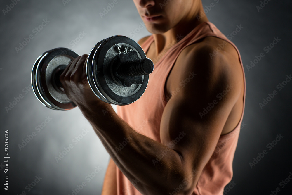 Sticker close up of young man with dumbbell