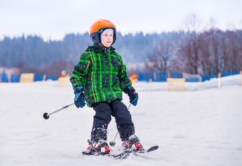 Fototapeta na wymiar Young skier slide down from snow hill