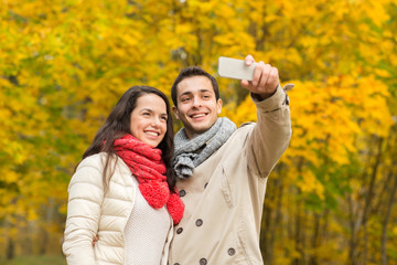Fototapeta premium smiling couple hugging in autumn park