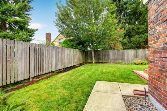 Backyard with wooden fence and walkway