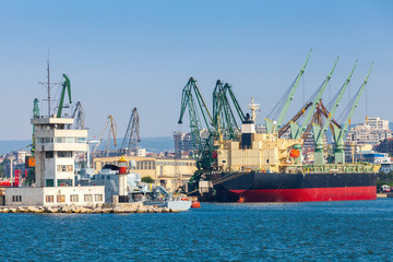 Fototapeta premium Big industrial cargo ship is loading in port of Varna, Bulgaria