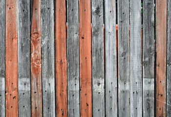 Close-up view of an old wooden fence with gray and orange mixed