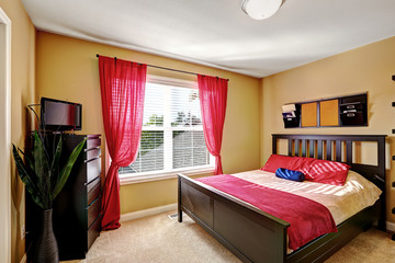 Simple yet practical bedroom design with red curtains