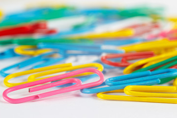 Bright multicolored office paperclips close up