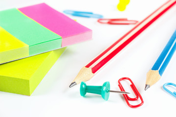 Multicolored stationery on white desktop close up