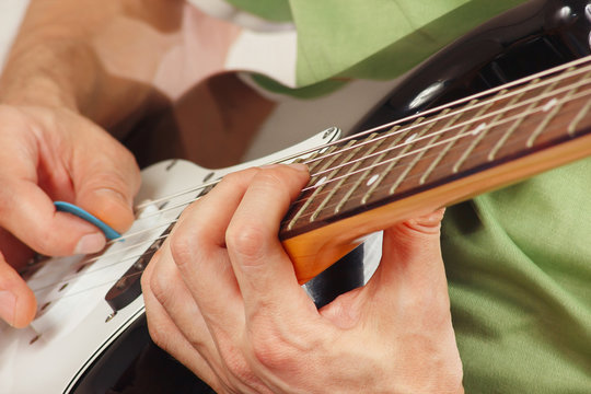 Hands of rock guitarist put guitar chords